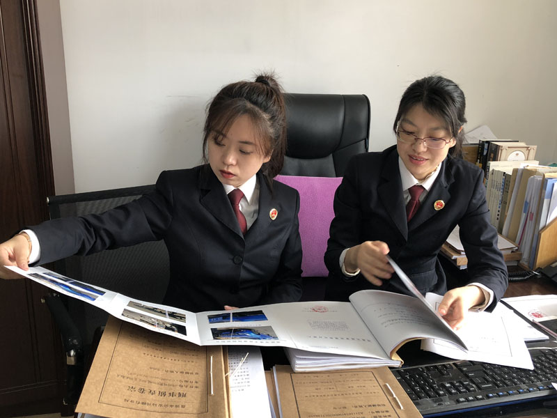 圖一：陳月（右一）告訴記者（左一）如何審查、分析案卷。