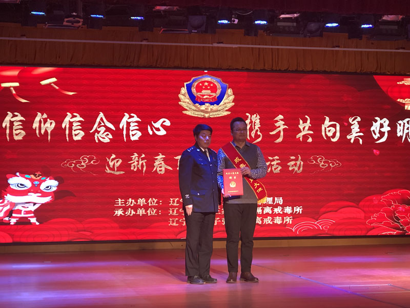 省司法廳副廳長椰永濤（左）為宋曉頒發(fā)聘書，佩戴戒毒公益大使綬帶